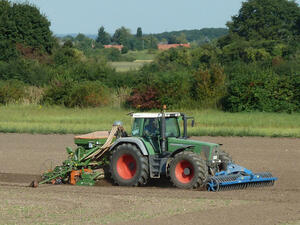 Bild vergrößern: Landwirtschaftsmaschine pflügt ein Feld um.